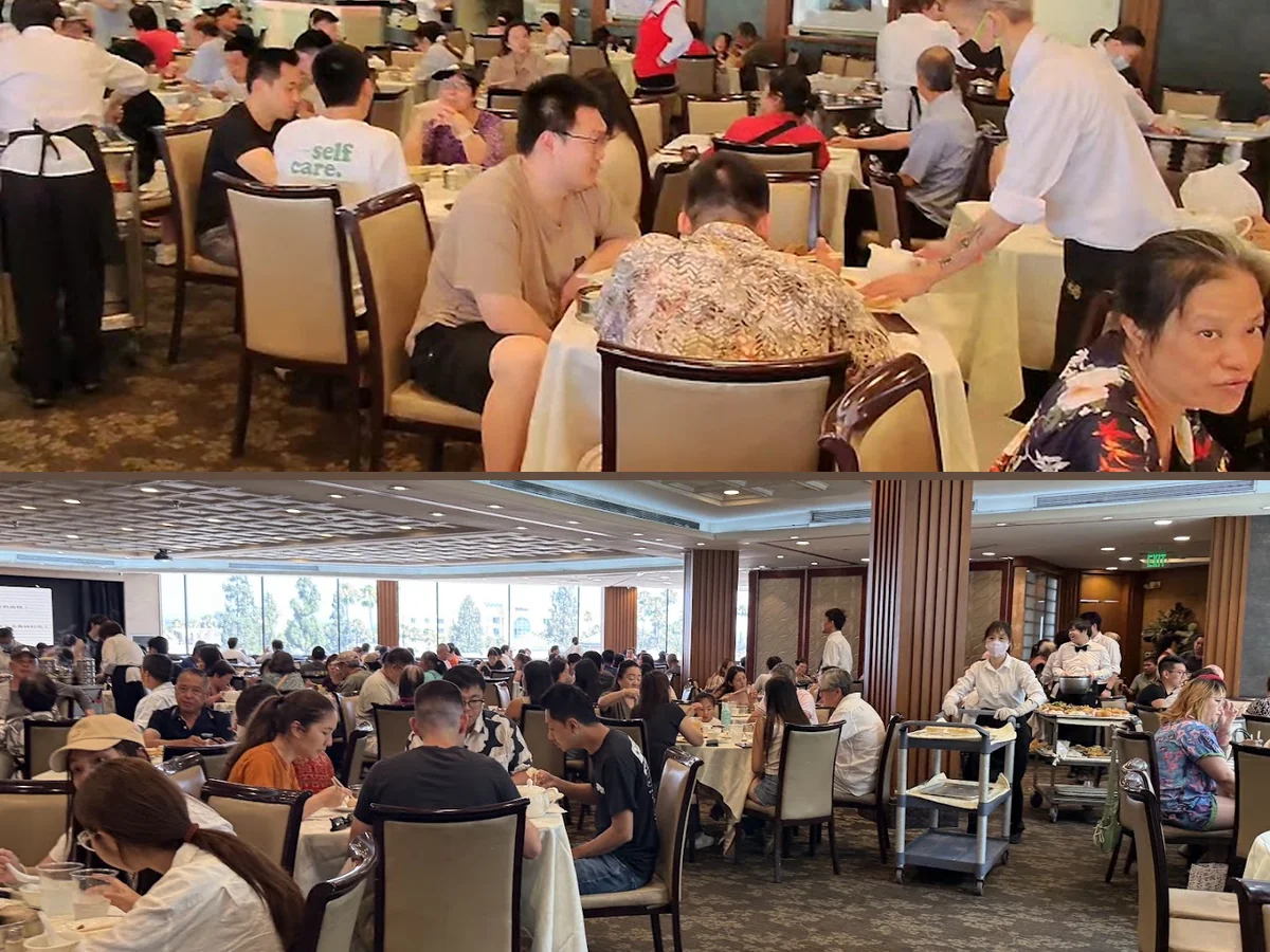 Busy seafood restaurant tables with steaming dishes.